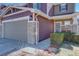 Inviting two-story townhome with a two-car garage, stone accents, and charming front porch at 5683 Raleigh Cir, Castle Rock, CO 80104