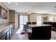 Open-concept kitchen with a center island, dining table, wood cabinets and sliding glass door at 5683 Raleigh Cir, Castle Rock, CO 80104