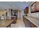 Modern kitchen featuring stainless steel appliances, center island, and sleek flooring at 5683 Raleigh Cir, Castle Rock, CO 80104