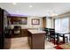 Modern kitchen with stainless steel appliances, center island, and adjacent dining area at 5683 Raleigh Cir, Castle Rock, CO 80104