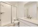 Bathroom boasts subway tile shower, marble floor, and white vanity at 10727 Snowdon St, Parker, CO 80134