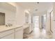 Spacious bathroom featuring double sinks, marble floors, recessed lighting, and a glass-enclosed shower at 10727 Snowdon St, Parker, CO 80134