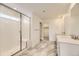 Modern bathroom featuring double sinks, white subway tile in the shower, marble tile floors, and recessed lighting at 10727 Snowdon St, Parker, CO 80134