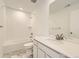 Bathroom features a white vanity, marble floor, and white subway tile shower at 10727 Snowdon St, Parker, CO 80134