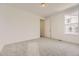Bedroom offers plush carpet, ensuite bath, and window with neighborhood view at 10727 Snowdon St, Parker, CO 80134