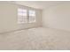 Bright bedroom with neutral carpet and two large windows offering plenty of natural light at 10727 Snowdon St, Parker, CO 80134