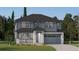 Charming two-story home featuring stone accents, a covered porch, and an attached two-car garage at 10727 Snowdon St, Parker, CO 80134