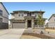 Charming two-story home with a landscaped front yard, stone accents, covered porch, and a two-car garage at 10727 Snowdon St, Parker, CO 80134