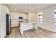 Bright eat-in kitchen featuring stainless steel appliances, white cabinets, and a large kitchen island at 10727 Snowdon St, Parker, CO 80134
