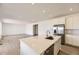 Modern kitchen with white cabinets, stainless steel appliances, an island with a sink, and hardwood floors at 10727 Snowdon St, Parker, CO 80134
