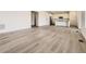 Open floor plan featuring hardwood floors connecting the living and kitchen areas, bathed in natural light at 10727 Snowdon St, Parker, CO 80134