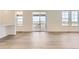 Bright living space with hardwood floors, a patio door, and two windows providing ample natural light at 10727 Snowdon St, Parker, CO 80134