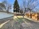 View of yard featuring trees, wooden fence and a lawn at 927 E 7Th Ave, Broomfield, CO 80020