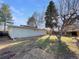 View of yard featuring trees, wooden fence and a lawn at 927 E 7Th Ave, Broomfield, CO 80020