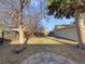 A relaxing backyard with green grass, trees, and wood fence at 927 E 7Th Ave, Broomfield, CO 80020