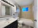 Well-lit bathroom features a combined tub and shower, complemented by neutral tiles and classic fixtures at 927 E 7Th Ave, Broomfield, CO 80020