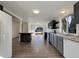 Modern kitchen featuring dark cabinets, granite counters, and stainless appliances at 927 E 7Th Ave, Broomfield, CO 80020