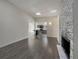 Open concept living room and kitchen area with brick fireplace and modern design at 927 E 7Th Ave, Broomfield, CO 80020