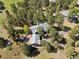 Aerial view of a secluded house with a green roof surrounded by lush greenery and mature trees at 1570 Blakcomb Ct, Evergreen, CO 80439