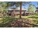 Lush backyard with a spacious deck offering a scenic view of nature at 1570 Blakcomb Ct, Evergreen, CO 80439