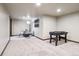 A finished basement area perfect for recreation, featuring a foosball table and dining set at 1570 Blakcomb Ct, Evergreen, CO 80439