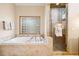 Bathroom features a separate shower, soaking tub, and a window providing natural light at 1570 Blakcomb Ct, Evergreen, CO 80439