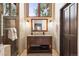 Bathroom vanity offers granite countertops, a tile backsplash, a sink, and lots of storage at 1570 Blakcomb Ct, Evergreen, CO 80439