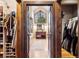 Entry to primary bathroom through closet doors features a large window and dual sinks at 1570 Blakcomb Ct, Evergreen, CO 80439