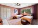 Bedroom has two twin beds, a large window, and matching rugs and ottomans at 1570 Blakcomb Ct, Evergreen, CO 80439