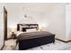 Cozy bedroom with warm lighting, a comfortable queen-size bed, and stylish decor at 1570 Blakcomb Ct, Evergreen, CO 80439