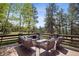 Large deck with comfortable seating, perfect for outdoor relaxation and enjoying the surrounding forest views at 1570 Blakcomb Ct, Evergreen, CO 80439