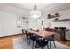 Elegant dining room with long table and modern chandelier at 1570 Blakcomb Ct, Evergreen, CO 80439