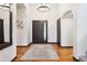 Elegant foyer with hardwood floors and grand chandelier at 1570 Blakcomb Ct, Evergreen, CO 80439