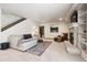 Comfortable living room features a stone fireplace, plush seating, and staircase at 1570 Blakcomb Ct, Evergreen, CO 80439
