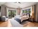 Cozy main bedroom with ceiling fan, balcony and large windows for beautiful views at 1570 Blakcomb Ct, Evergreen, CO 80439