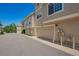 A townhouse complex, focusing on light-brown garage doors numbered 9522 at 9522 Silver Spur Ln, Highlands Ranch, CO 80130