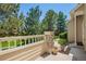 Home's exterior boasts mature trees and a fence surrounding the front yard, enhancing privacy and curb appeal at 9522 Silver Spur Ln, Highlands Ranch, CO 80130