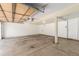 A spacious, empty garage with concrete floor, white walls, and an automatic door opener at 9522 Silver Spur Ln, Highlands Ranch, CO 80130