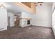 Spacious living room with a fireplace, large windows, and carpeted floors, perfect for gatherings at 9522 Silver Spur Ln, Highlands Ranch, CO 80130