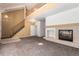 Open concept living room boasts a fireplace, staircase, and lots of natural light creating an inviting atmosphere at 9522 Silver Spur Ln, Highlands Ranch, CO 80130