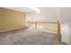 A loft space with a railing, carpeted floor, and a skylight, bathed in natural light at 9522 Silver Spur Ln, Highlands Ranch, CO 80130