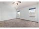 Well-lit main bedroom features neutral carpet, two windows, and ample space at 9522 Silver Spur Ln, Highlands Ranch, CO 80130
