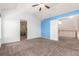 Large carpeted main bedroom features a ceiling fan, and a door leads to another room at 9522 Silver Spur Ln, Highlands Ranch, CO 80130