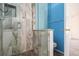 The bathroom features a decorative tiled shower with glass door and blue accent wall at 9522 Silver Spur Ln, Highlands Ranch, CO 80130