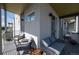 Relaxing covered balcony features modern outdoor furniture, decor, and a neighborhood view at 2197 S Clermont St, Denver, CO 80222