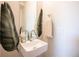 Stylish bathroom sink with modern faucet, decorative leaf, and neutral towel, creating a fresh aesthetic at 2197 S Clermont St, Denver, CO 80222