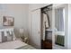 This well-lit bedroom features a large closet and bedside table, complemented by neutral tones at 2197 S Clermont St, Denver, CO 80222