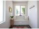 Bright entryway with seating nook, large window, and decorative mirror at 2197 S Clermont St, Denver, CO 80222