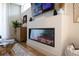Modern electric fireplace framed by a sleek white wall, glass coffee table, and stylish decor at 2197 S Clermont St, Denver, CO 80222