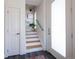 Hallway featuring wood stairs and a glass-paneled door, creating a bright and modern space at 2197 S Clermont St, Denver, CO 80222